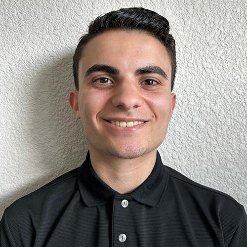 Chris Lizardi smiling and wearing a black shirt