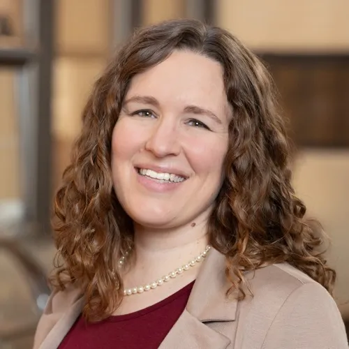 Christi Fannon wearing a necklace and smiling.