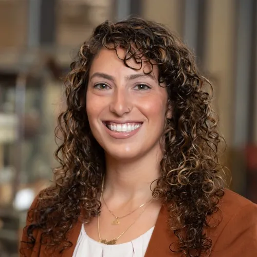 Dr. Tonia Guida smiling while wearing a suit coat.