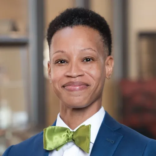 LaKesha Henry smiling while wearing a suit and bowtie.