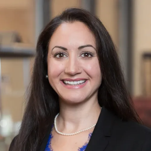 Selina Keilani wearing pearls and a suit jacket.