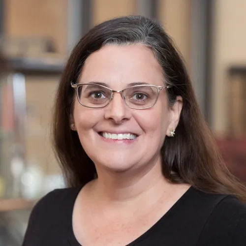 Michelle Lee wearing glasses and smiling.