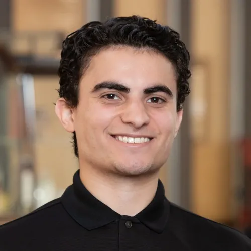 Christopher Lizardi Clemente a polo shirt and smiling.