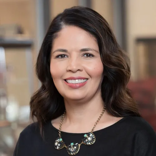 Cathy Rodriguez wearing a necklace and smiling.