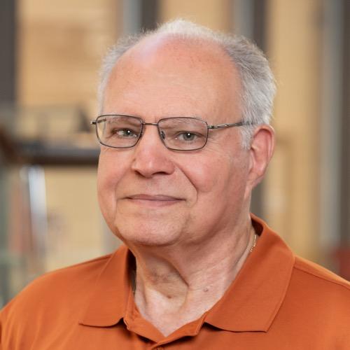 Dr. Stephen Saklad wearing glasses and a Longhorn polo.