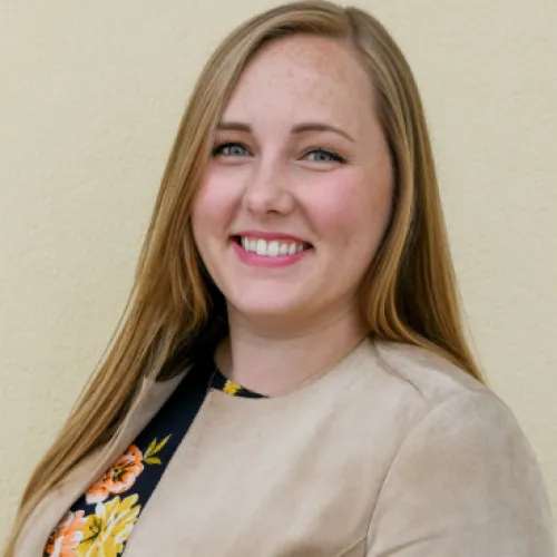 Dr. Ashley Crouch smiling and wearing a blazer