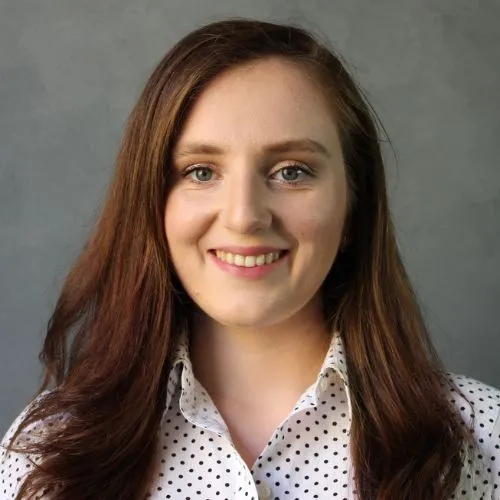 Mariya Raleigh smiling and wearing patterned shirt