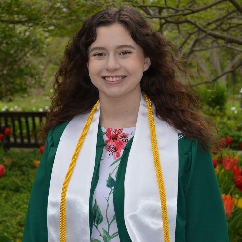Rachel Clark smiling in a graduation gown