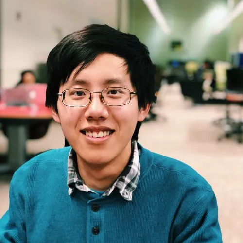 Tingzen Wang smiling and wearing a green sweater