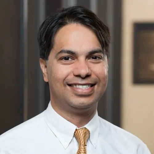 Som Mukhopadhyay smiling in the Pharmacy building