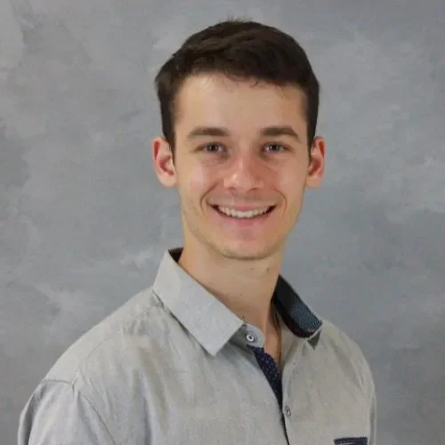 Jakob Ramon smiling in an indoor setting.