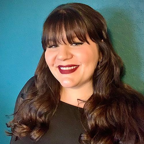 Jenny Carrasco smiling in an indoor setting