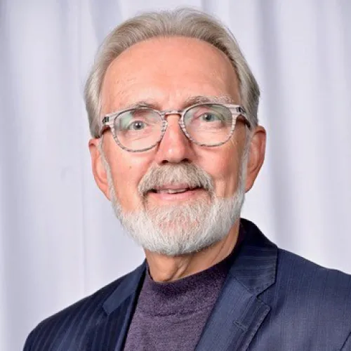 Jim Smeeding smiling in an indoor setting