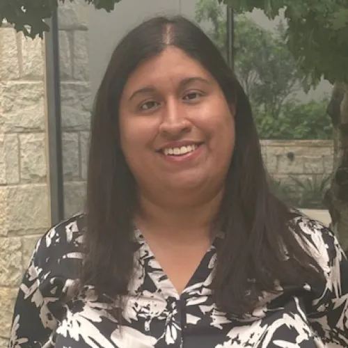 Rosalinda White smiling in an outdoor setting