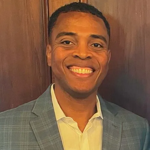 Antonio Burns smiling in an indoor setting