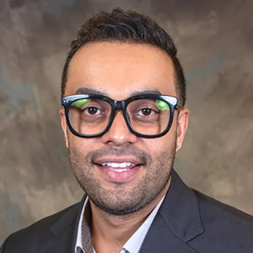 Abofazl Sadeghi smiling and wearing a suit jacket