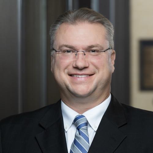 Dr. Chris Frei smiling in an indoor setting