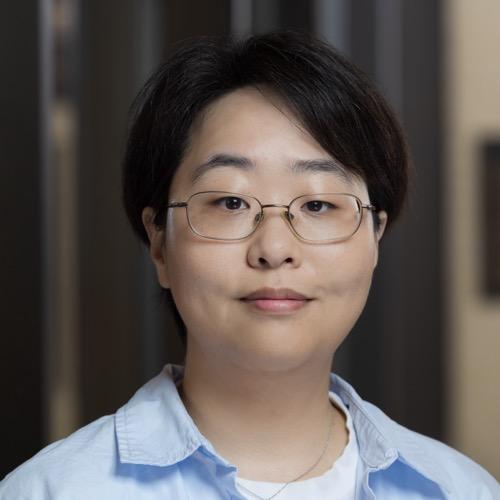 Dr. BJ Kim wearing glasses and a collared shirt.