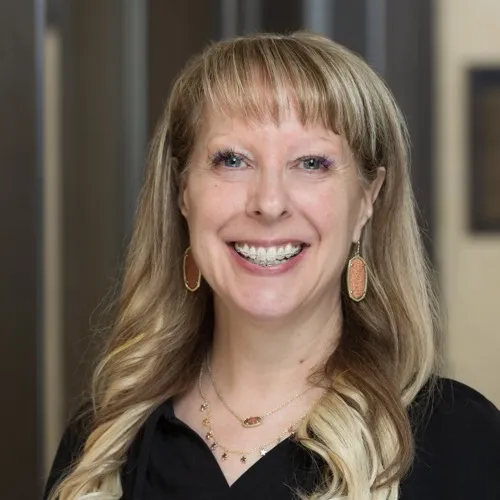 Barbara King wearing a necklace and smiling.