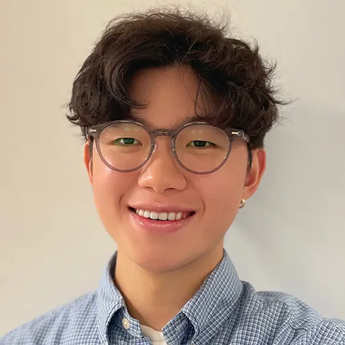 Siang-Hao Cheng smiling and wearing a checkered shirt