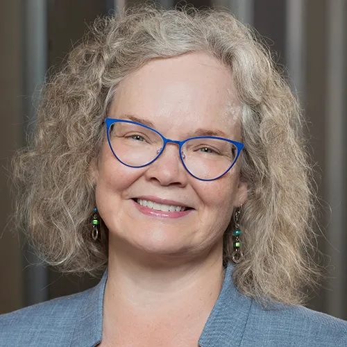 Dr. Cindy WalkerPeach smiling in an indoor setting