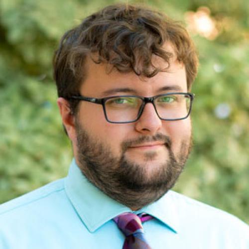 Justin Harlin smiling in an outdoor setting