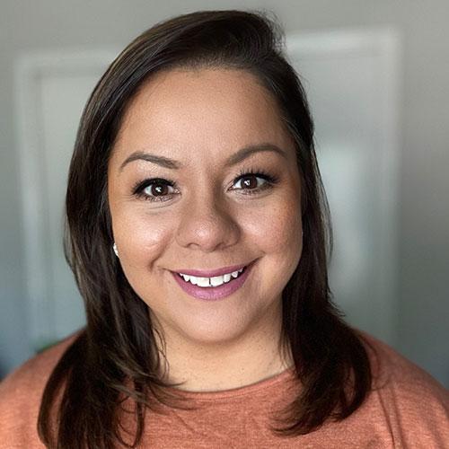 Lori Reyes smiling in an indoor setting