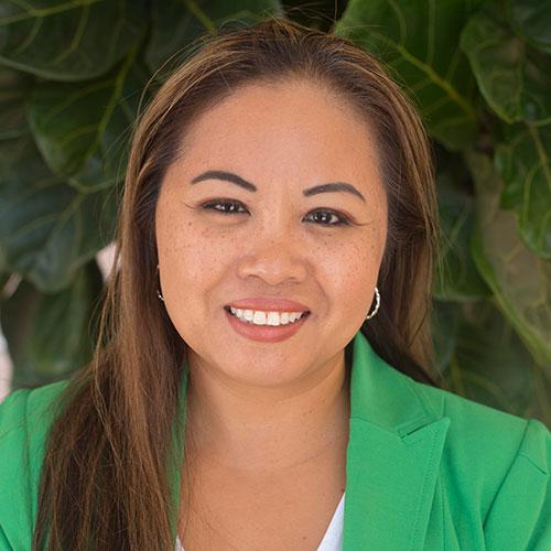 Pik Martinez smiling in an outdoor setting