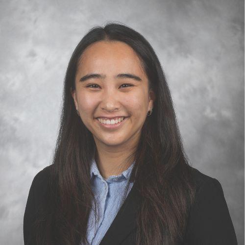 Sunny Trieu smiling and wearing a black blazer