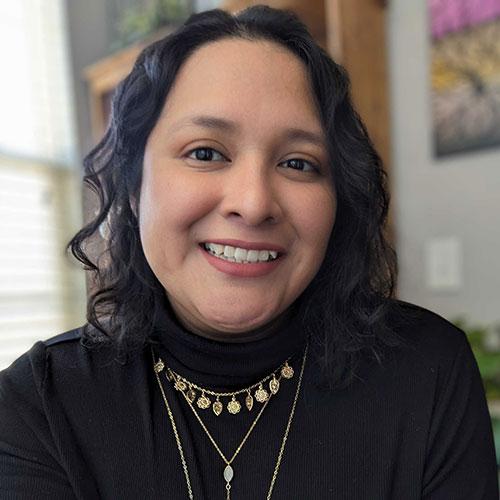 Daniela Carrizales Sauceda smiling in front of a window