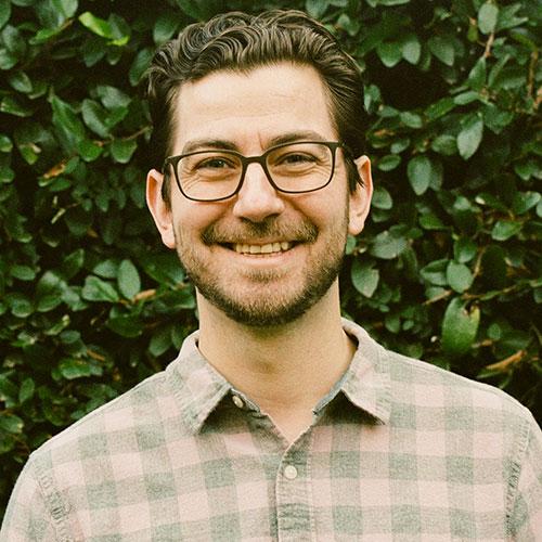 Dr. Lucas Hill smiling in an outdoor setting