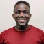 James Baffoe smiling and wearing a red shirt
