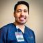 Daniel Tapia smiling and wearing blue scrubs