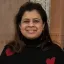 Mrinmayee Lakkad smiling and wearing a black sweater
