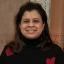 Mrinmayee Lakkad smiling and wearing a black sweater