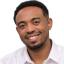 Filmon Wolde smiling and wearing a white shirt
