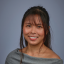Beverly Fuerte smiling in front of a gray background
