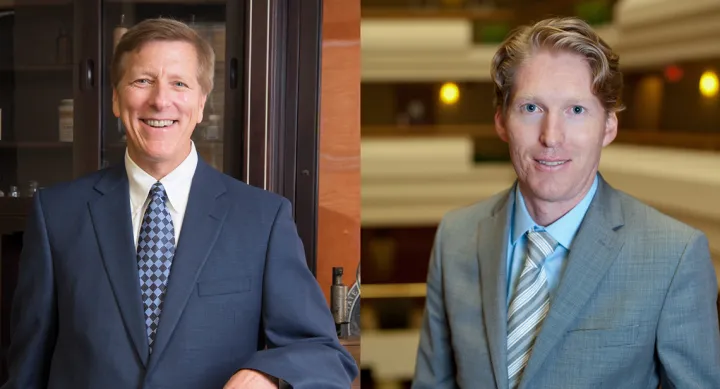 Dr. Bill Williams and Dr. Hugh Smyth smiling and wearing suits