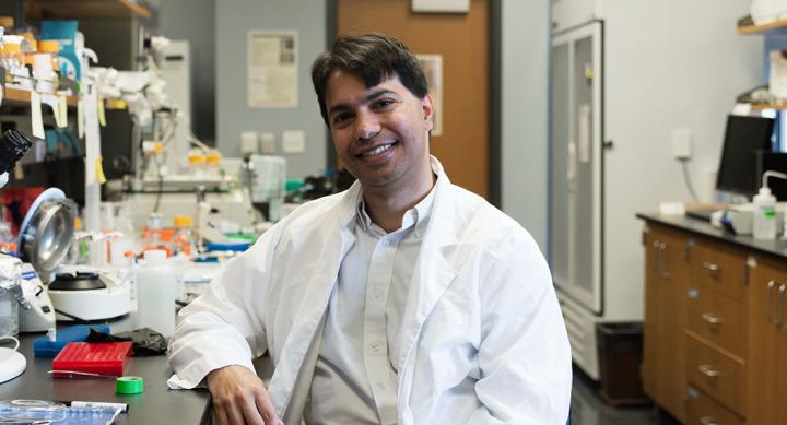 Dr. Som Mukhopadhyay smiling in research lab