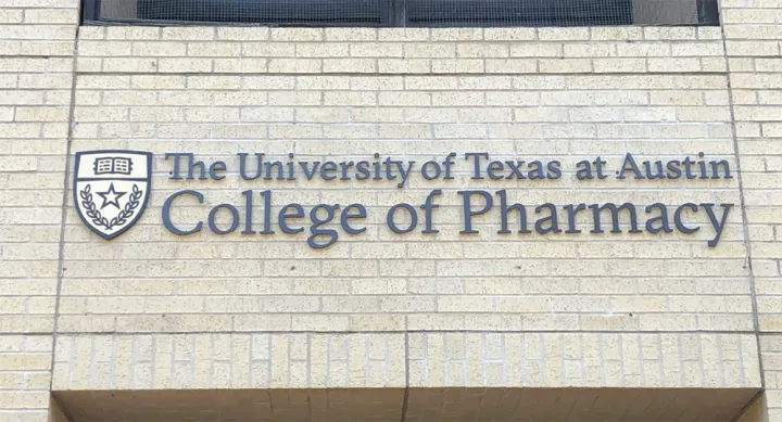 Brick facade of Pharmacy building with affixed text, "The University of Texas at Austin College of Pharmacy"