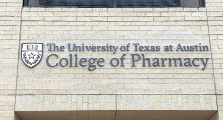 Brick facade of Pharmacy building with affixed text, "The University of Texas at Austin College of Pharmacy"