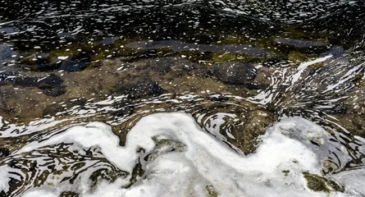 Swirling ocean water that it foamed in swirls.