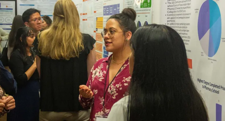 A person standing in front of research posters.