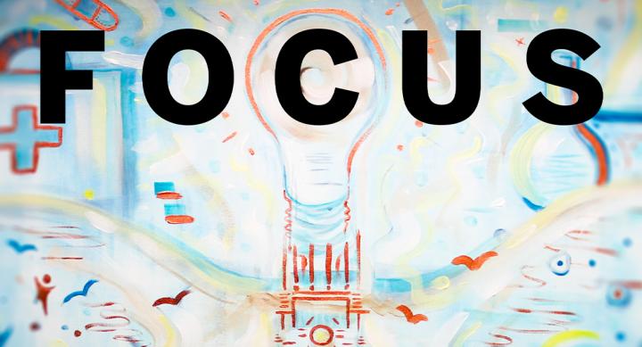 A lightbulb emerging out of the top of the UT Austin tower with the word "FOCUS" superimposed over the image.