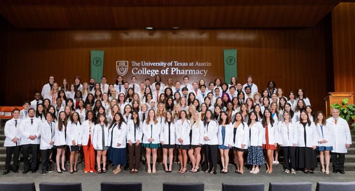 Group photo of Dean Poloyac and incoming Pharm.D. students at 2025 White Coat Ceremony