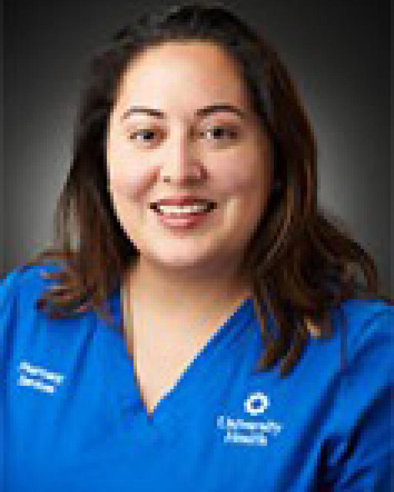 Dr. Jennifer Caballes smiling in an indoor setting