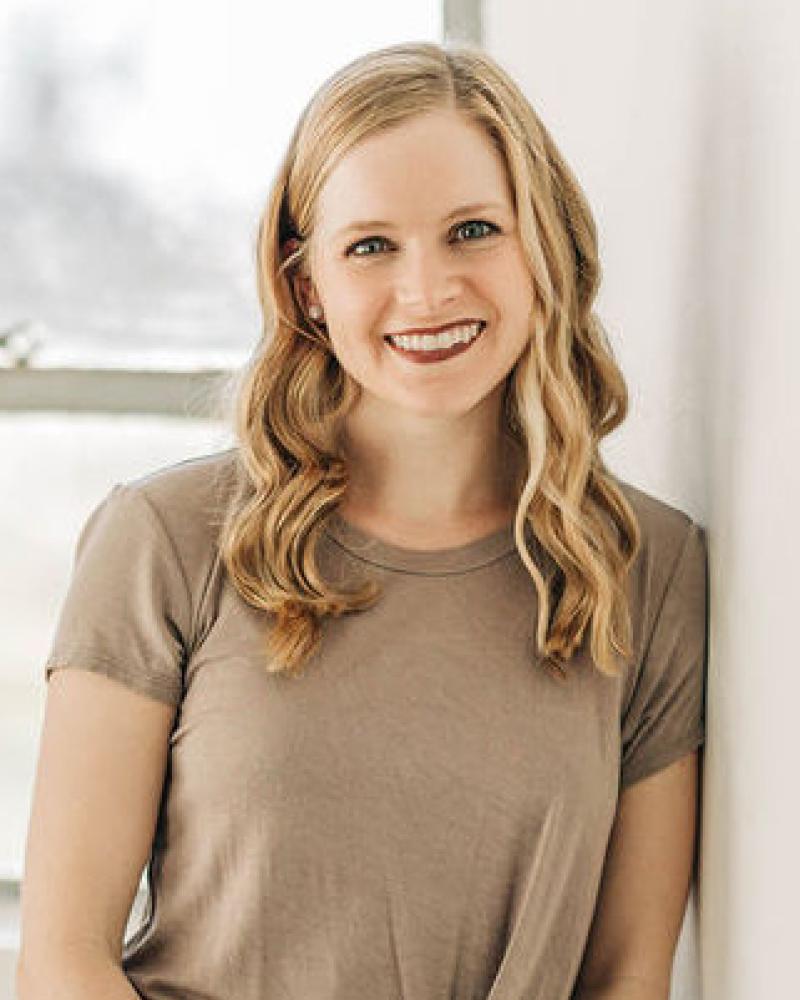 Dr. Kelli Sims smiling in an indoor setting