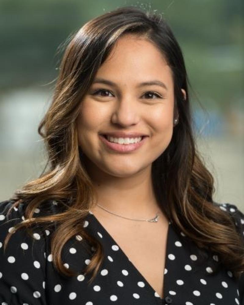 Dr. Lauren Ratrut smiling in a polka dot blouse