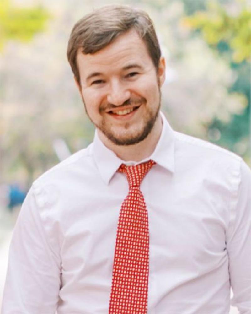 Dr. Elijah Martin smiling in an outdoor setting