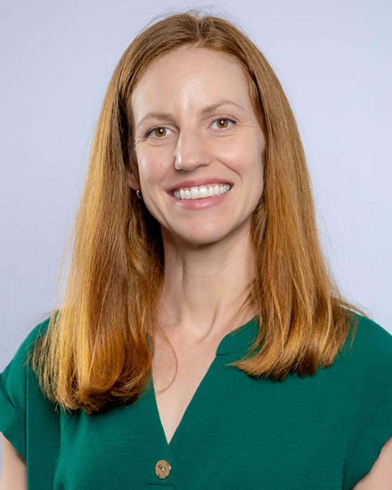 Dr. April Hinds smiling and wearing a green top